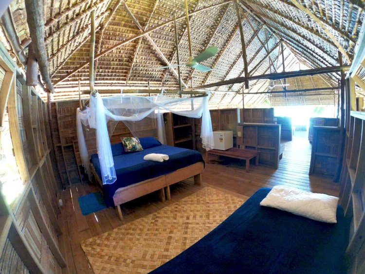 Queen bed at the back of a Family Bungalow