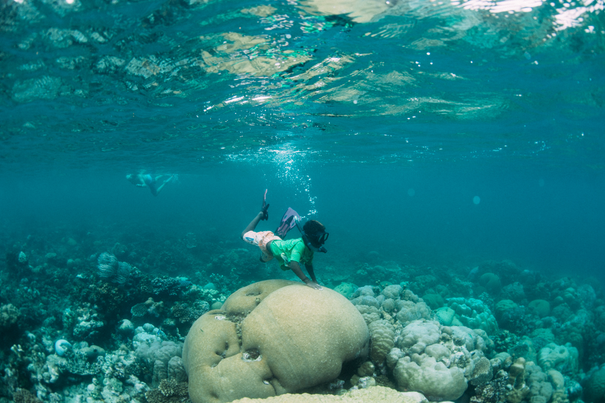 Snorkelling over coral reef at Papatura