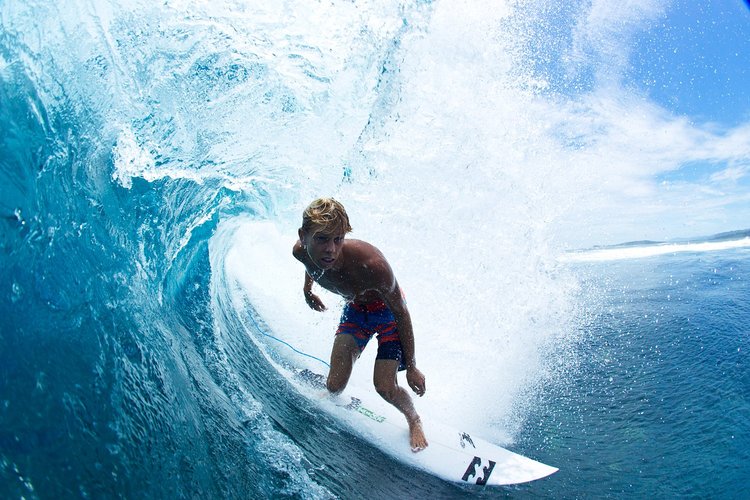Surfer riding a reef break in the Solomon Islands